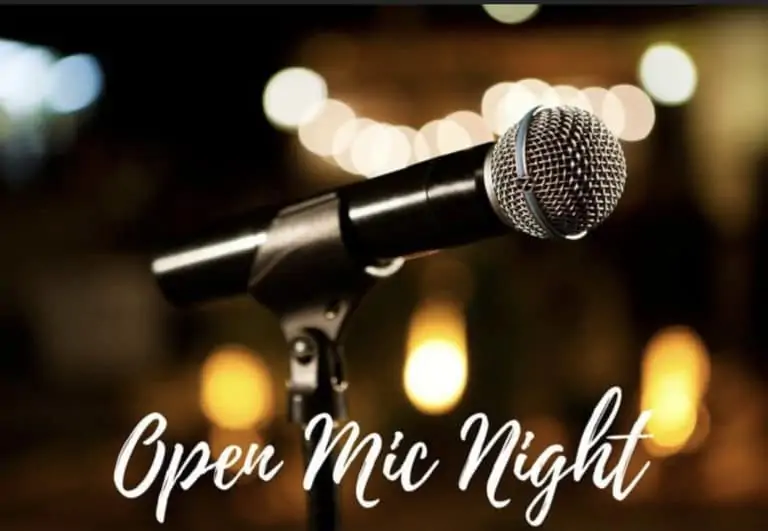 Open Mic Night image with microphone with patio lights in the background.